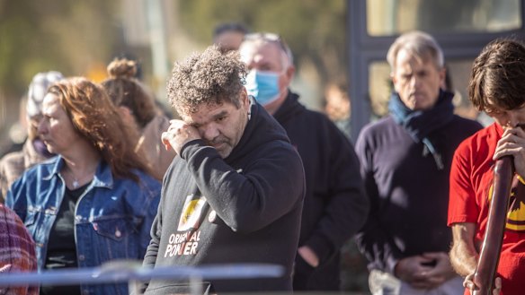 A person reacts as Archie Roach's body is escorted by the Southern Warriors Aboriginal Motorcycle Club outside the Aboriginal Health Service, Nicholson St in Fitzroy.
