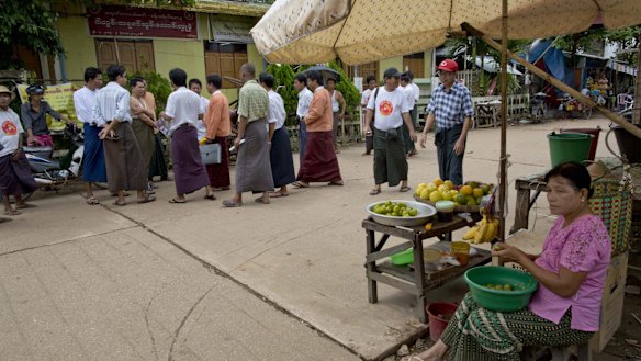 Candidates and supporters of Myanmar Opposition Leader Aung San Suu Kyi's National League of Democracy party campaign in Yangon on Tuesday.