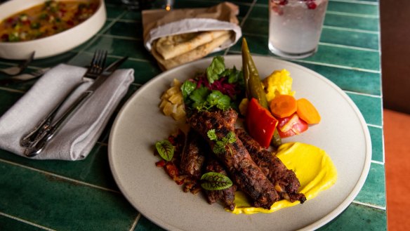 Kofta shipud with salad, yoghurt tahini sauce, pickles, herbs, preserved lemon and laffa flatbread. 