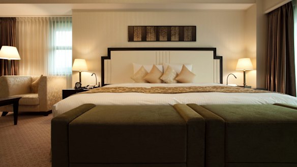 The room's huge bed is wider than it is long.