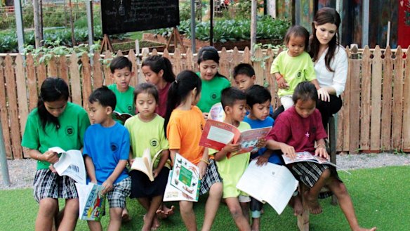 Australian Tara Winkler from the Cambodian Children's Trust with students in Cambodia. Ms Winkler campaigns to stop so-called "orphan tourism".