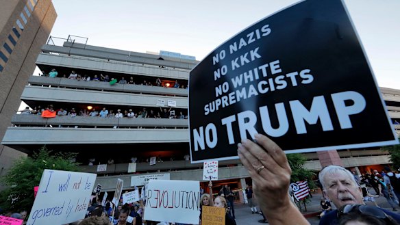 People protest outside the Phoenix Convention Centre on Tuesday.