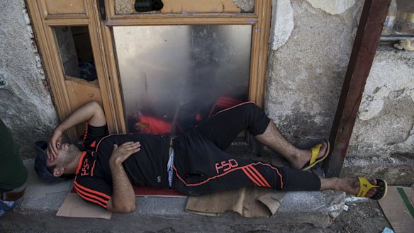 A migrant alseep on a street in the town of Presevo, Serbia, on Monday.