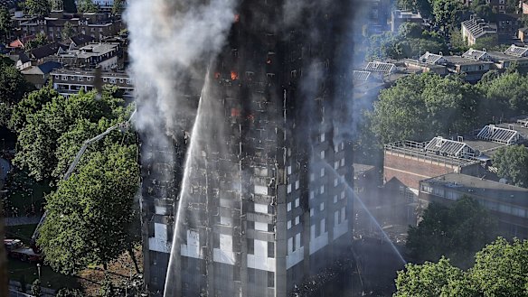 Firefighters tackle the building after a huge fire engulfed the 24-storey Grenfell Tower in Latimer Road, West London. 