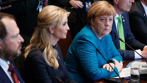 German Chancellor Angela Merkel sits next to Ivanka Trump during a roundtable discussion.
