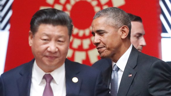 Changing of the guard: Xi Jinping and Barack Obama pass each other at the APEC summit's opening session in Lima.