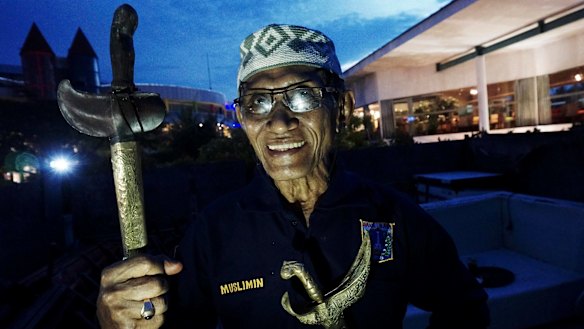 Muslimin Suparman, a "pawang hujan" or rain shaman, performs rituals to control the elements. 