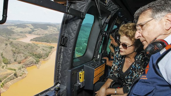 Brazilian President Dilma Rousseff, accompanied by Minas Gerais state governor Fernando Pimentel, looks out over the dam site.