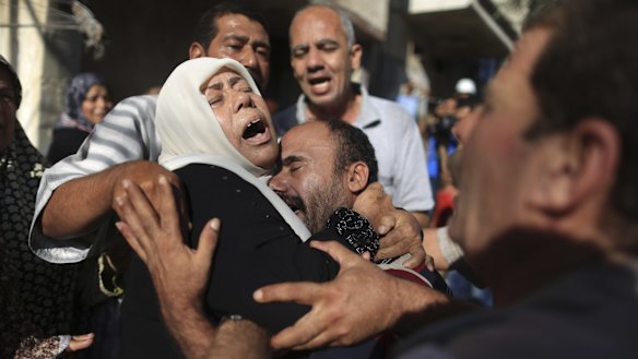 Relatives mourn during the funeral for the four children.