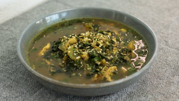 Free-range chicken soup garnished with hemp seeds and oil.