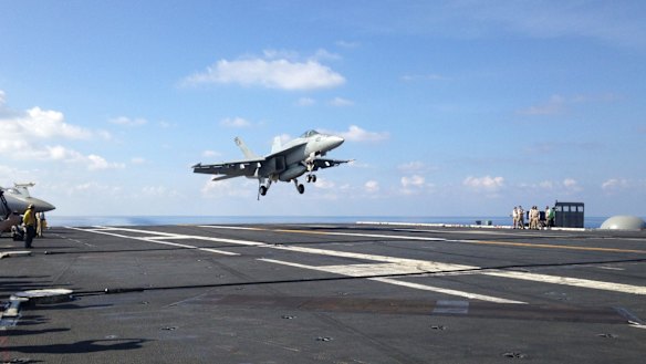 An FA-18 jet fighter lands on a US aircraft carrier in the South China Sea this month.