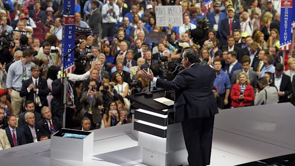 Chris Christie speaks while others chant.