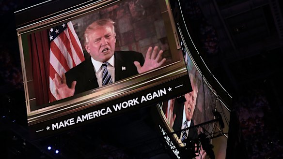 Donald Trump is seen speaking on a screen during the RNC.