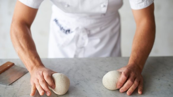Shaping the dough step 5: Roll each ball gently on the work surface to make it even and round.