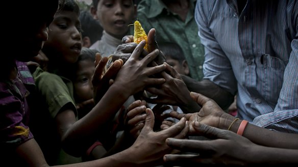 Rohingya refugees rush to relief supplies donated by the crew of the Nautical Aliya.