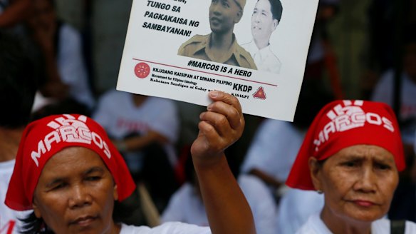 Supporters of the late Philippine dictator Ferdinand Marcos  await the rulling in Manila.