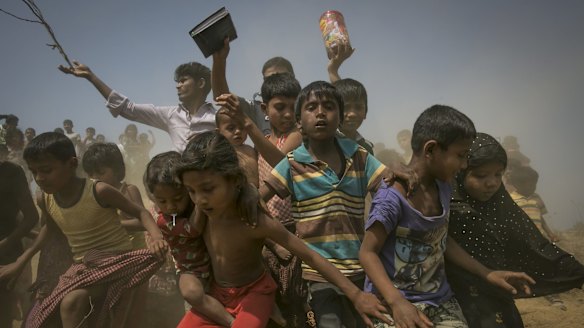 Rohingya refugees run to the crew of the Nautical Aliya as they provide relief supplies at the Balu Khali camp in Chittagong, Bangladesh, on Wednesday. 
