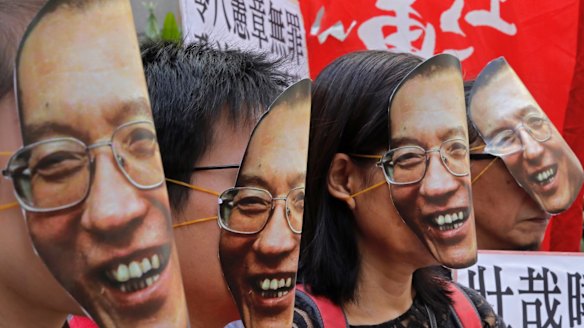 Protesters wear masks of Chinese Nobel Peace laureate Liu Xiaobo during a demonstration demanding his release outside the Chinese liaison office in Hong Kong in June 2017.