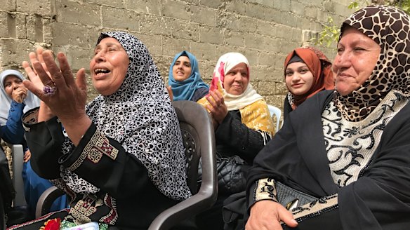 Older women sing at the Aged Care Association in Gaza, a country where many women face domestic abuse or economic uncertainty.