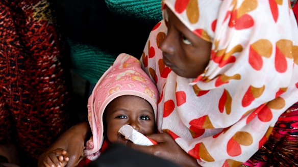 Medina Humed feeds her baby Ahmed Abdu emergency food at a health post in Dubti, Ethiopia's Afar region.