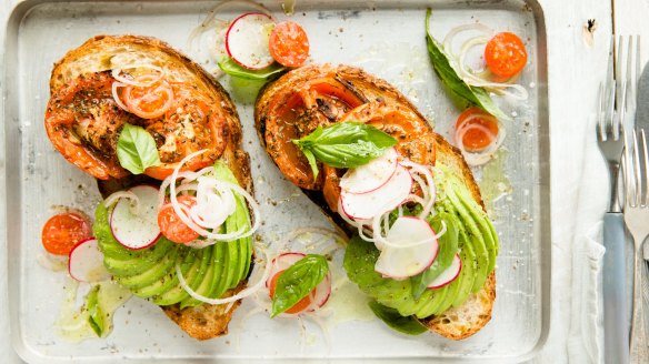 Avocado toast with roast tomatatoes and herb salad. 