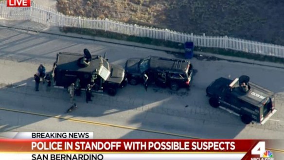 Armored vehicles surround an SUV following a shootout in San Bernardino.