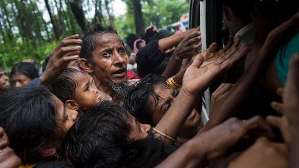 Rohingya scuffle to get aid from local volunteers at Kutupalong, Bangladesh, on Friday.