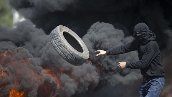 Palestinians burn tyres during clashes with Israeli troops near Ramallah, West Bank, on Friday.