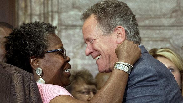 Representative Gilda Cobb-Hunter, left, reacts with former South Carolina Governor David Beasley after a ceremony where Governor Nikki Haley signed a bill to remove the Confederate flag.