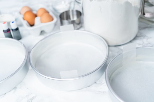 Butter or baking spray is your friend when lining cake tins with with baking paper.