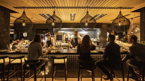 Chef Alejandro Saravia (centre) in the open kitchen inside Victoria by Farmer's Daughters.