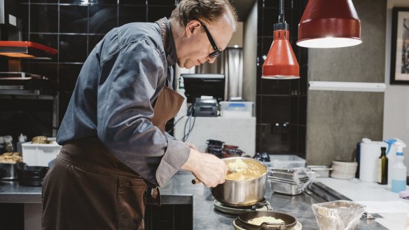 Chef Philippe Mouchel prepares a dish at Philippe restaurant.