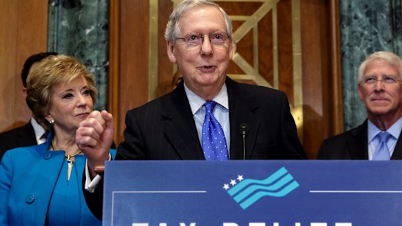 Senate Majority Leader Mitch McConnell, flanked by, Small Business Administration Administrator Linda McMahon, and Senator Roger Wicker.