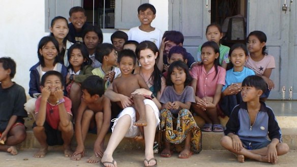 Tara Winkler (seen here with Cambodian children in 2007) set up her own orphanage in  Battambang, in the west of the country, before turning away from centre-based care for children, which she now calls a "trap".