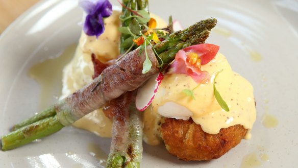 Eggs benedict with jamon-wrapped asparagus spears.