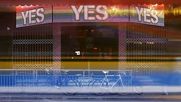 A bus leaves light trails as it passes a bar promoting the 'Yes' vote in central Dublin.