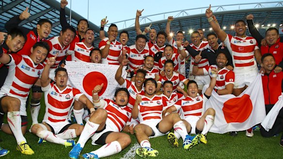 Cherry Blossoms in bloom: Japan players celebrate after defeating South Africa.