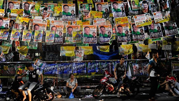 People wait for results in polling centres after voting ended in Manila on Monday.