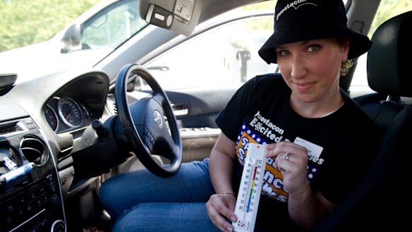 The temperature exceeded this thermometer's maximum inside the lighter coloured car.