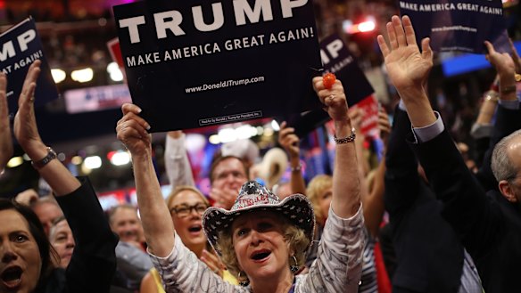Delegates hold campaign signs for Donald Trump.