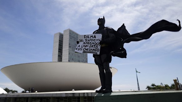 An anti-government demonstrator dressed as Batman protests against corruption at the National Congress in Brasilia. 