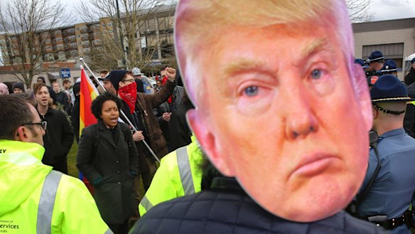 Several hundred pro-Trump and anti-Trump demonstrators gather at a rally at the state capitol in  Washington, on  March 4.