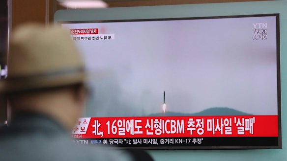 A man watches a TV news program reporting the North Korea's missile firing with a file footage, in Seoul, South Korea, on Saturday.