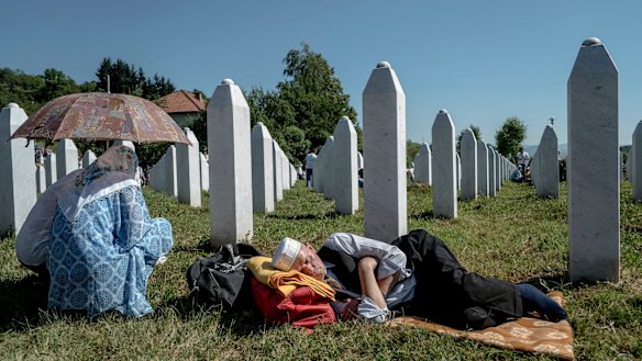 Mourners keep a vigil at a grave in the Srebrenica-Potocari Memorial Centre and Cemetery in Bosnia.