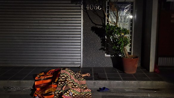 A person killed by masked men lies in the street in Manila, part of President Rodrigo Duterte's drug crackdown. 