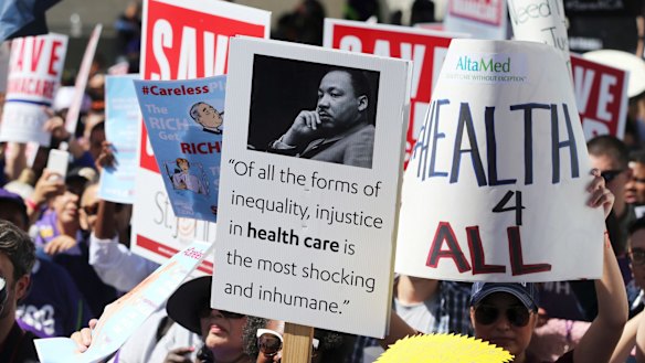 Hundreds of people march through downtown Los Angeles protesting Trump's plan to dismantle the Affordable Care Act.