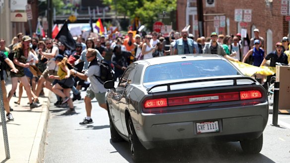 A vehicle drives into a group of protesters demonstrating against a white nationalist rally in Charlottesville.