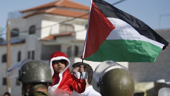 The Palestinian flag held by a child in the West Bank in 2013.