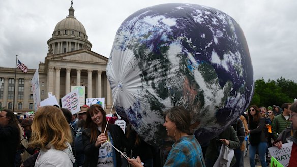 Members of the Oklahoma Nature Conservancy carry an inflatable globe during the March For Science   in Oklahoma City.