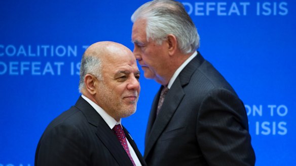 US Secretary of State Rex Tillerson, right, passes behind Iraqi Prime Minister Haider al-Abadi as he prepares to address the Meeting of the Ministers of the Global Coalition on the Defeat of ISIS, last week.